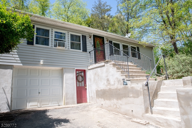 a view of a house with a backyard