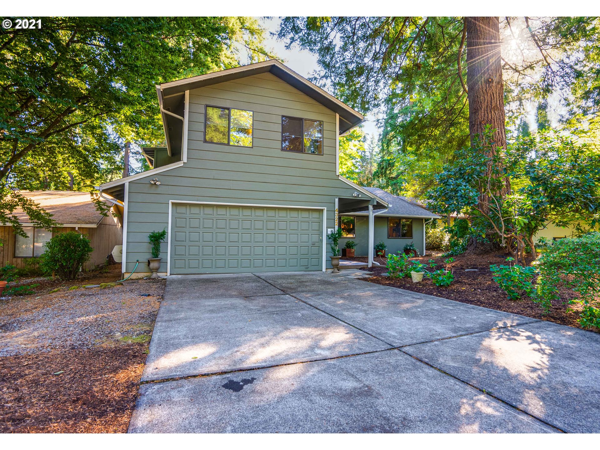 a front view of a house with a yard and a garage