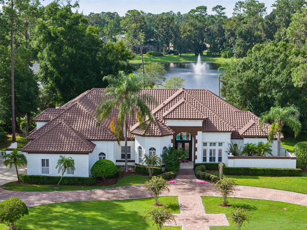 a aerial view of a house with a yard table and chairs