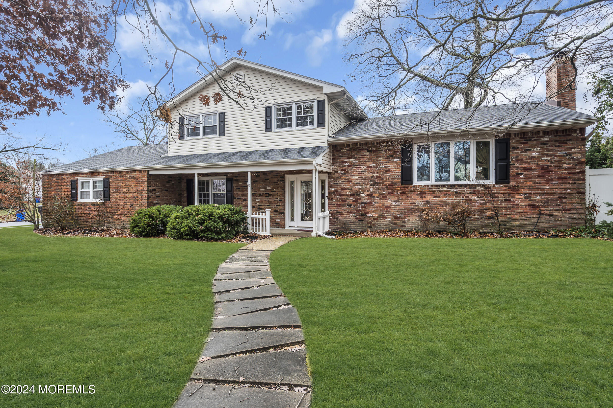 a front view of a house with a garden