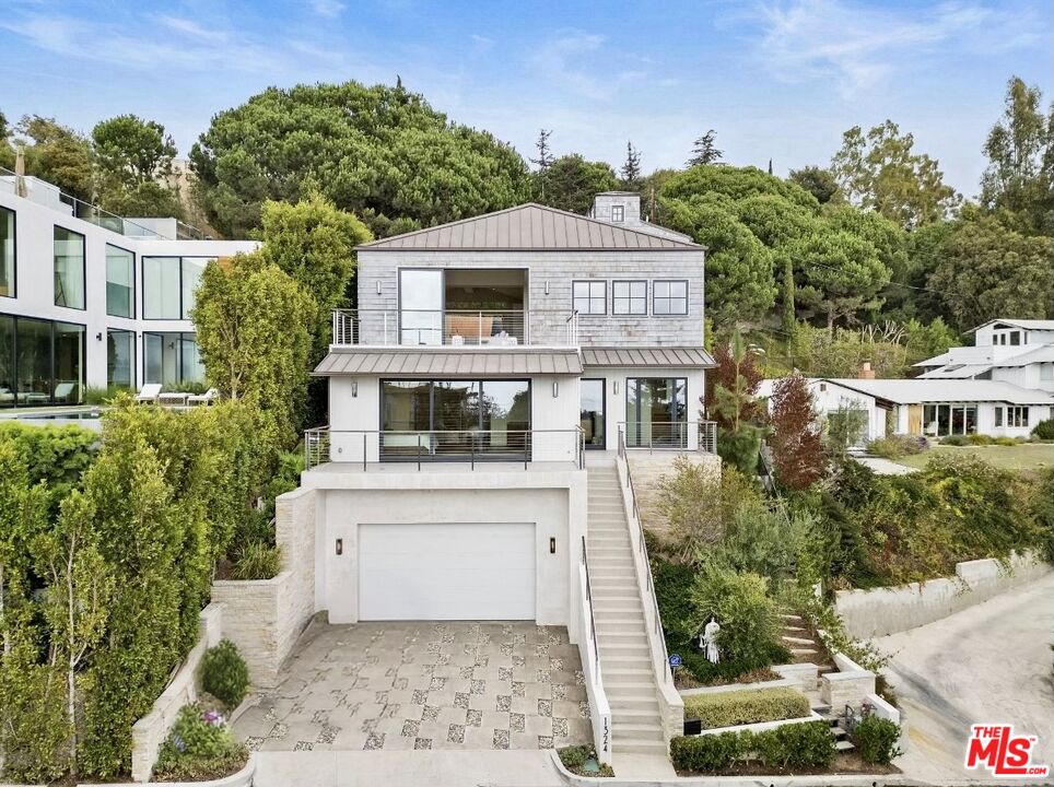 a aerial view of a house with a yard and potted plants