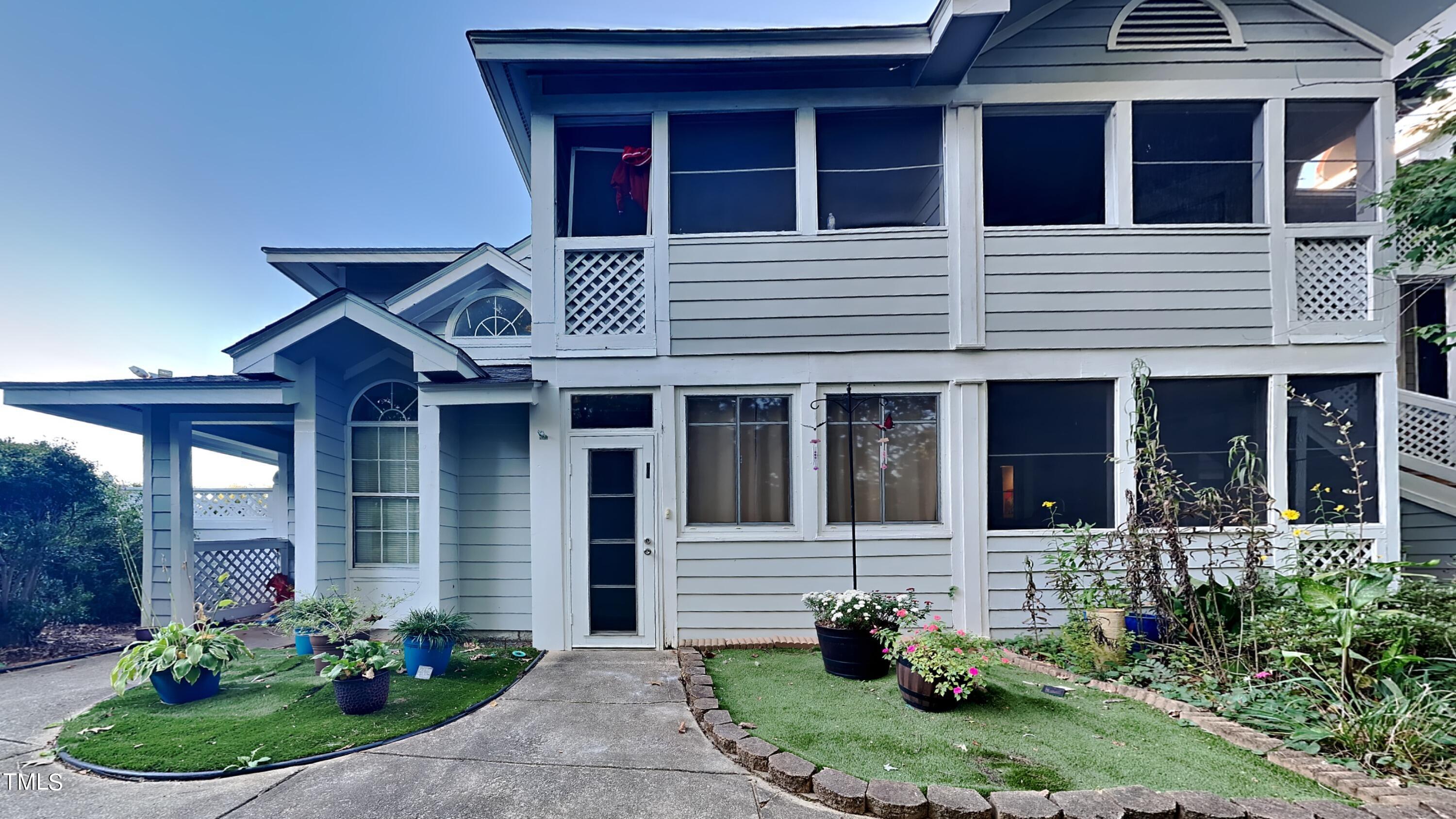 a front view of a house with porch and garden