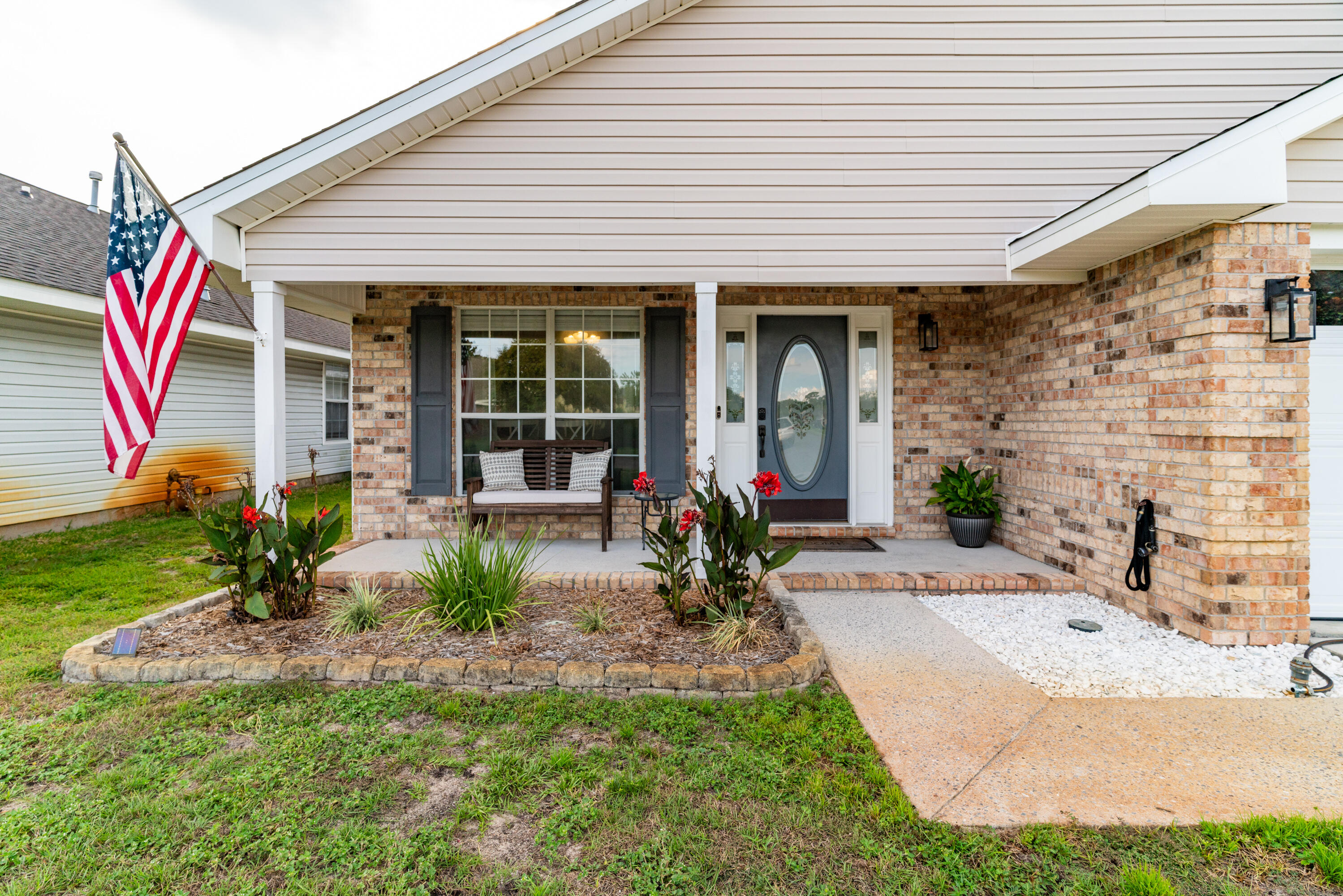 a front view of a house with garden and porch