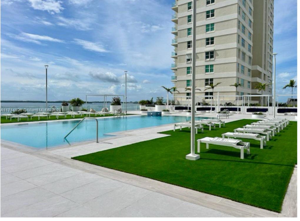 a view of a swimming pool with a lawn chairs