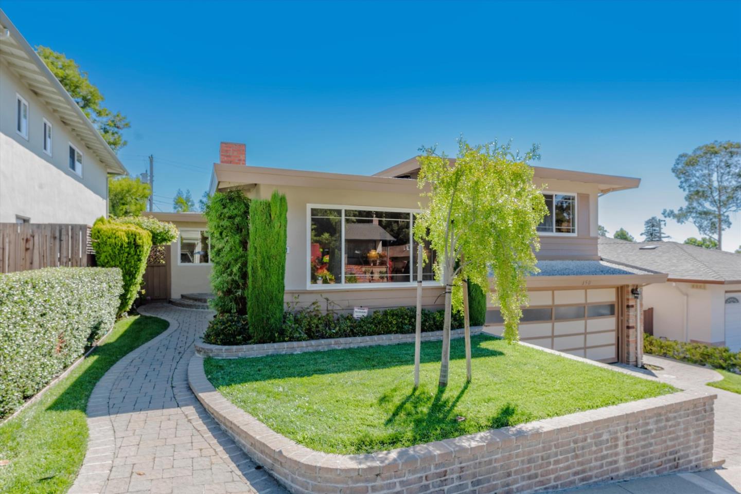 a view of an house with backyard space and patio