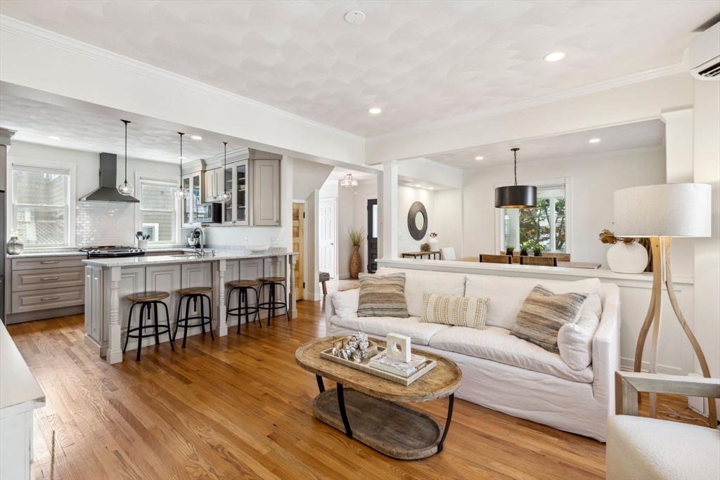 a living room with furniture and kitchen view