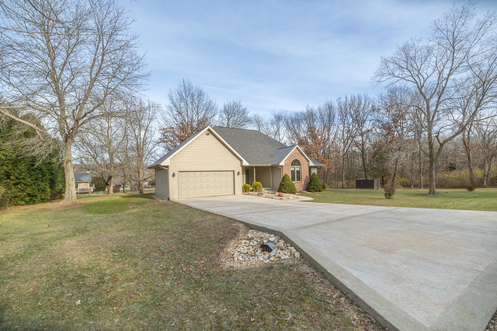 a view of a large house with a big yard and large trees