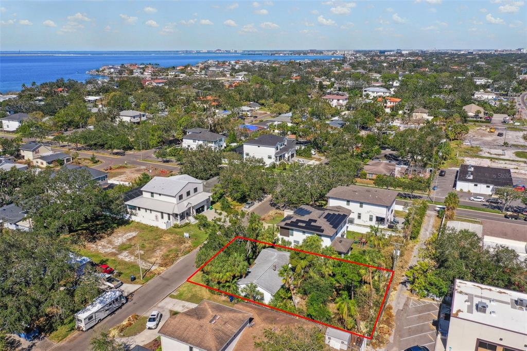 an aerial view of residential houses with city view