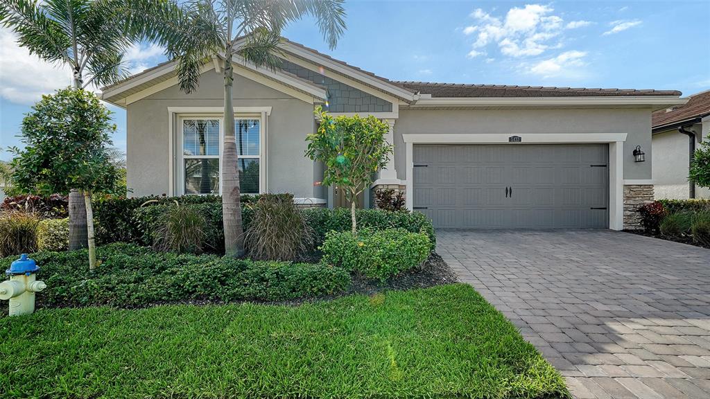 a front view of a house with a yard and garage