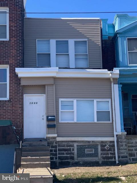 a front view of a house with stairs