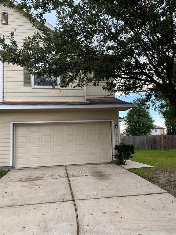 a side view of a house with a yard and garage