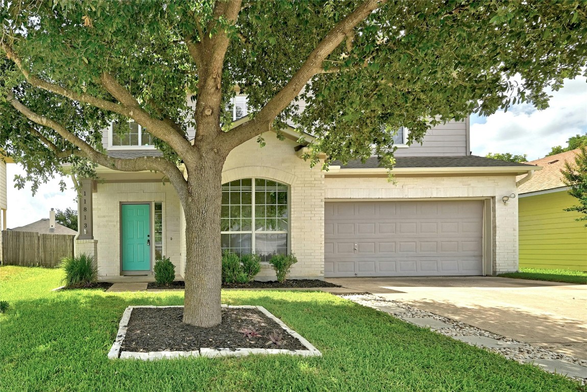 a front view of a house with a yard and garage