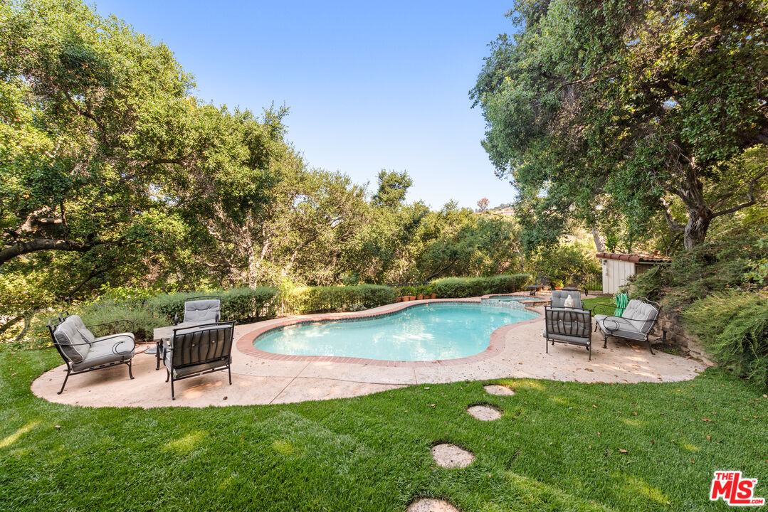 a view of a chairs and table in the garden