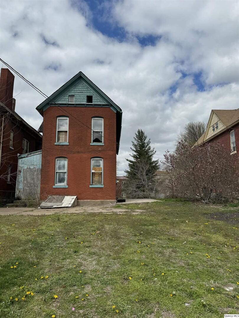 a big house with yard in front of it