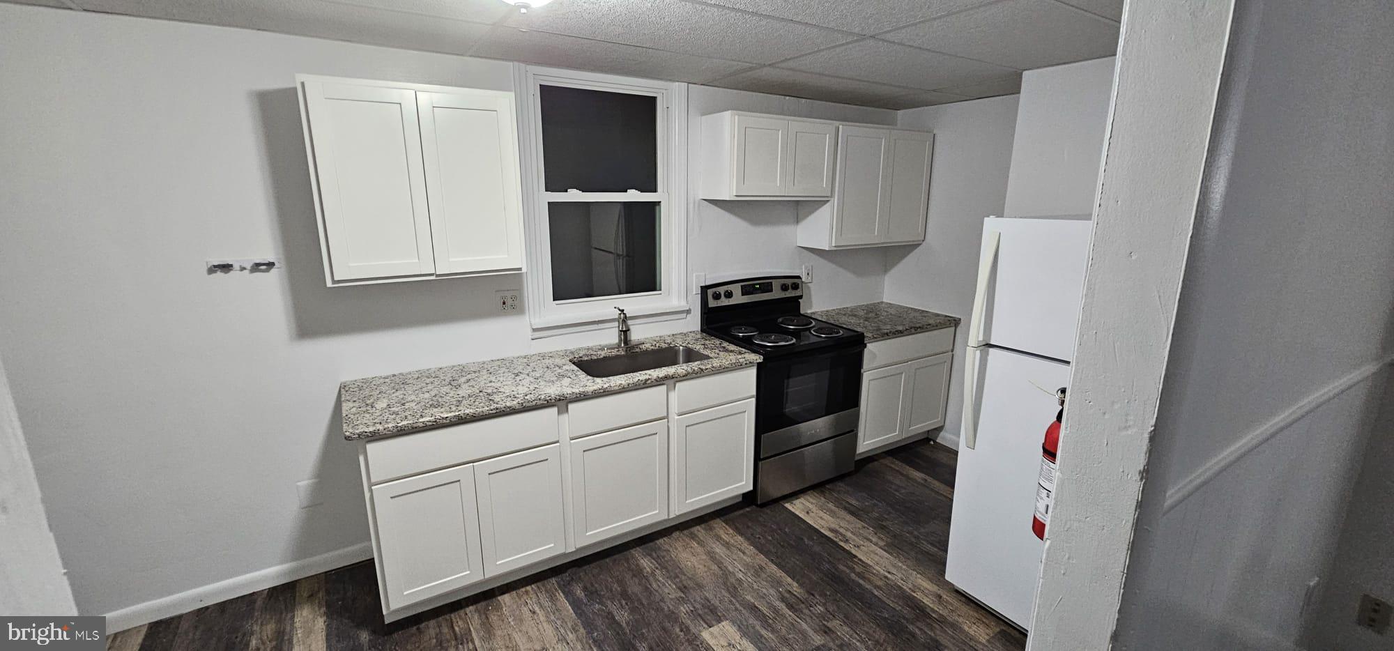 a kitchen with refrigerator and stove