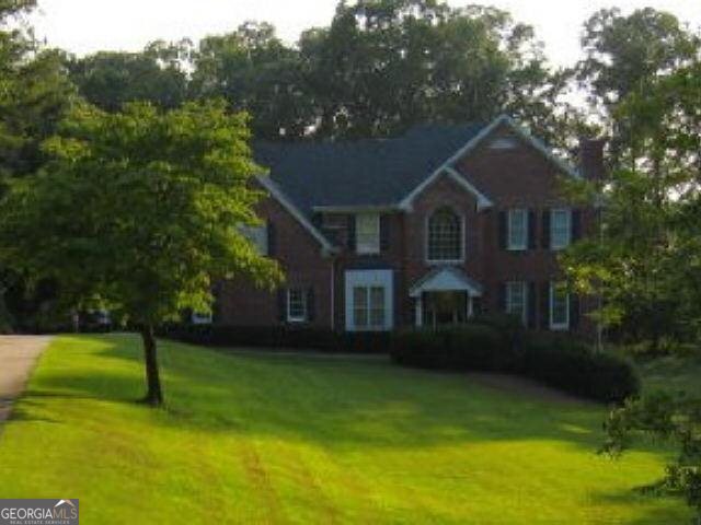 a front view of a house with a garden