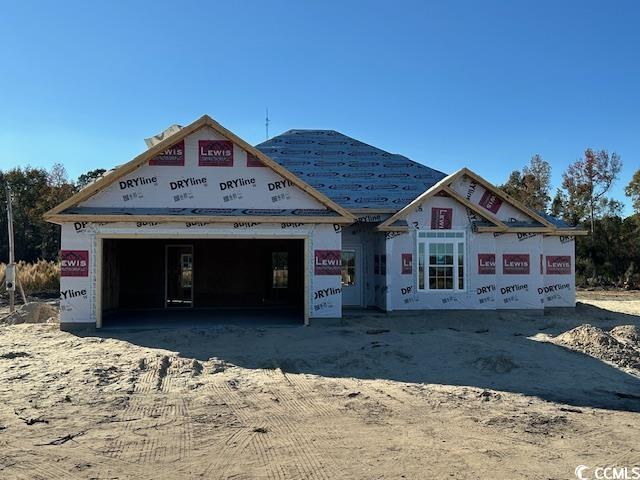 Property under construction with a garage