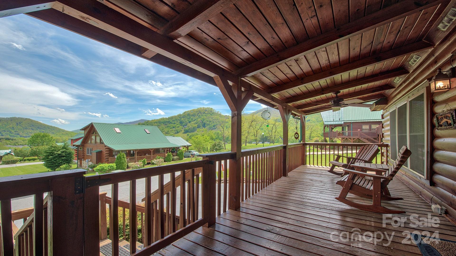 a balcony with wooden floor outdoor seating and city view