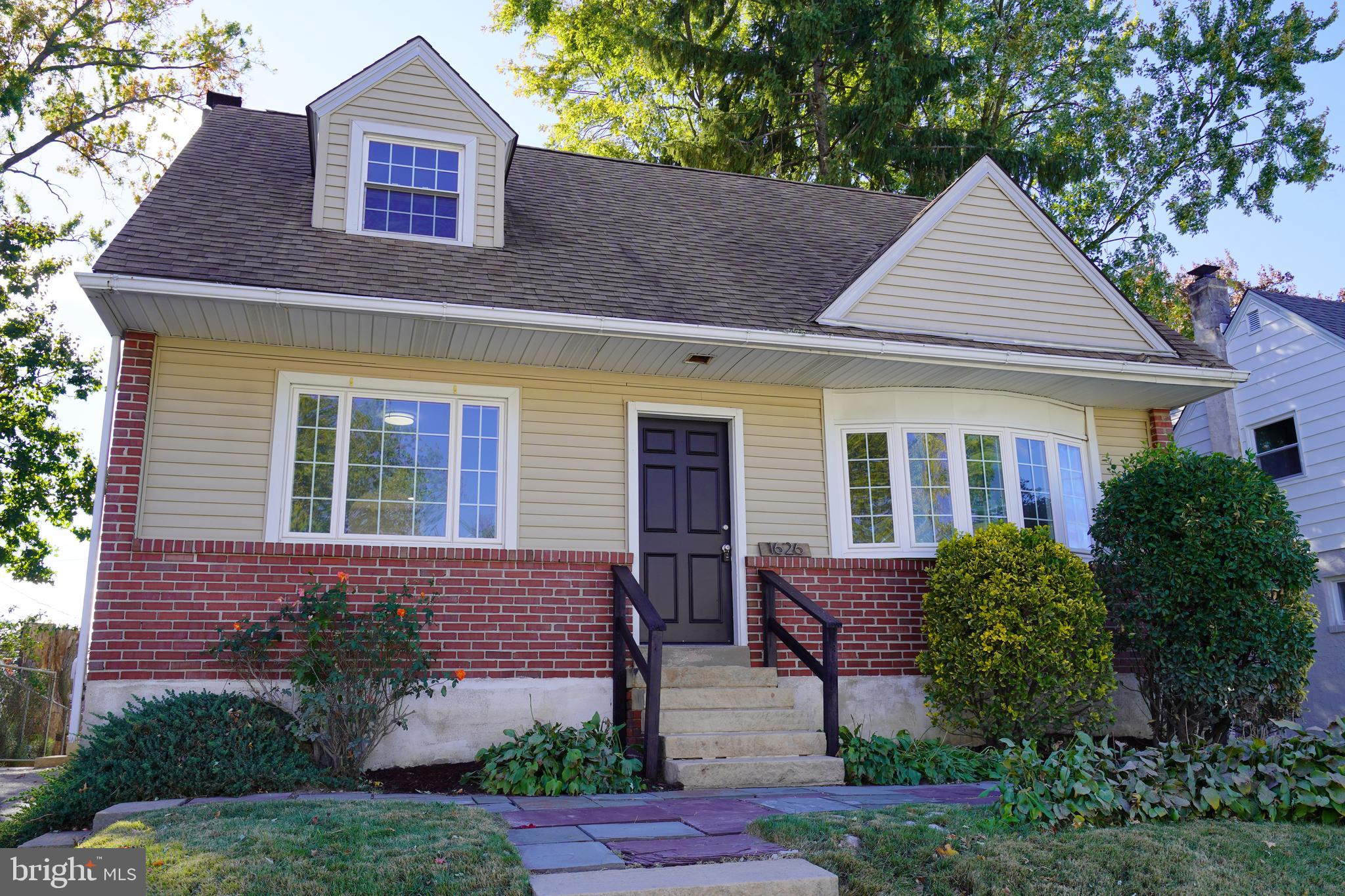 a view of a house with a yard and plants