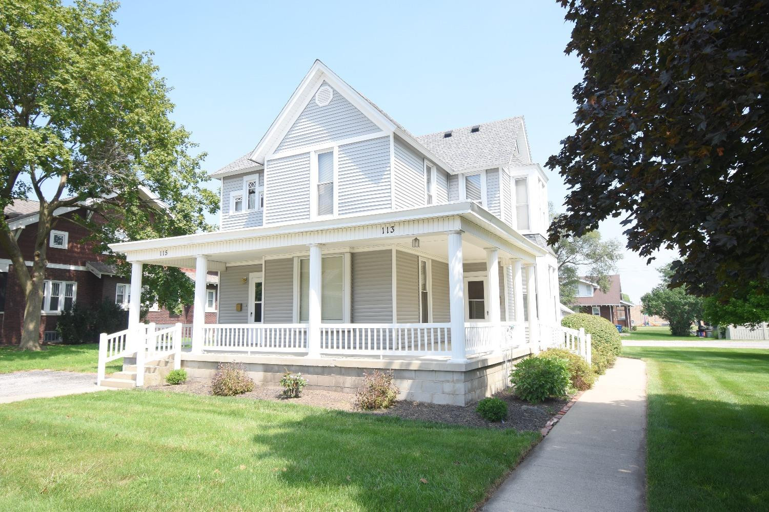 a front view of a house with a yard table and chairs