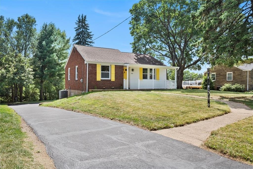 a front view of house with yard and trees