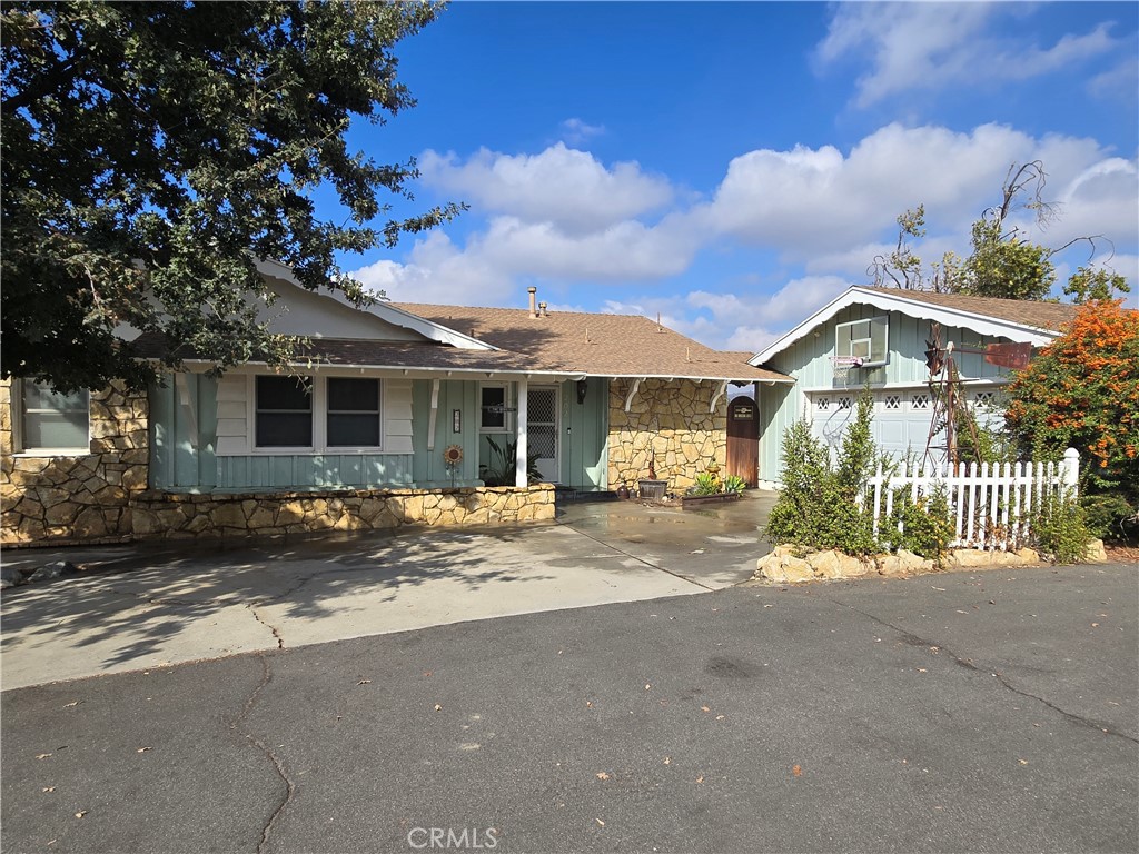 a view of a house with a yard and pathway