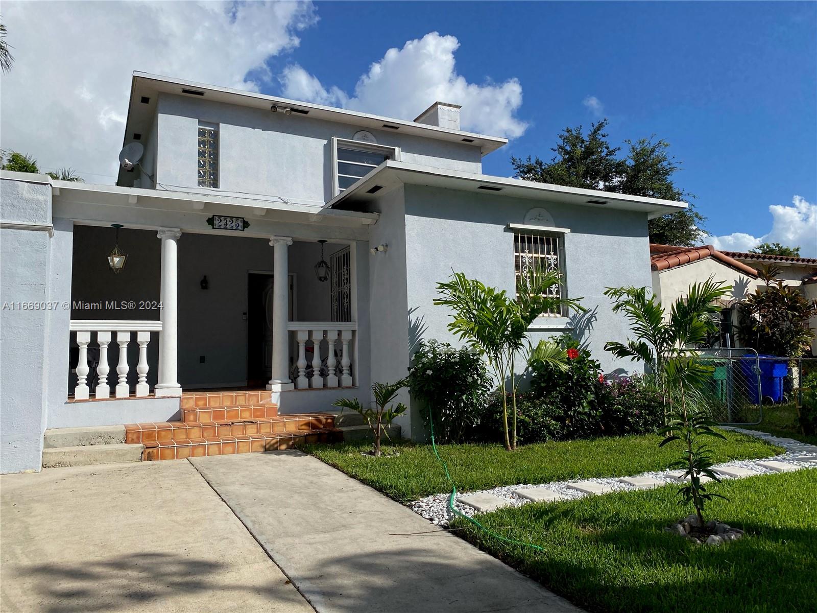 front view of a house with a yard