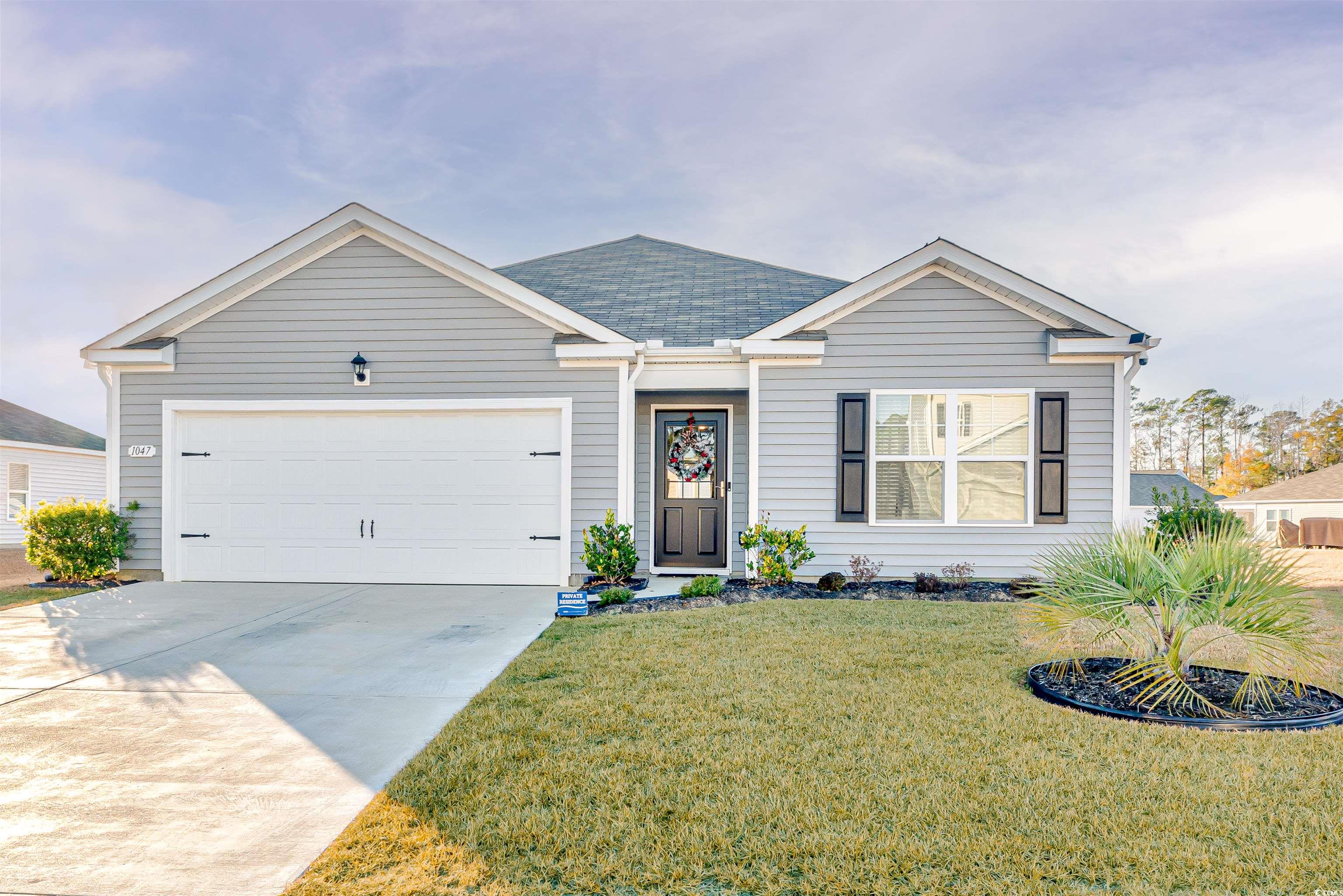 View of front of home featuring a garage and a fro