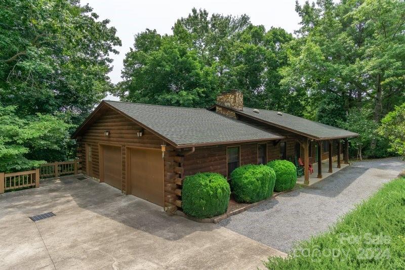 a backyard of a house with potted plants and large tree