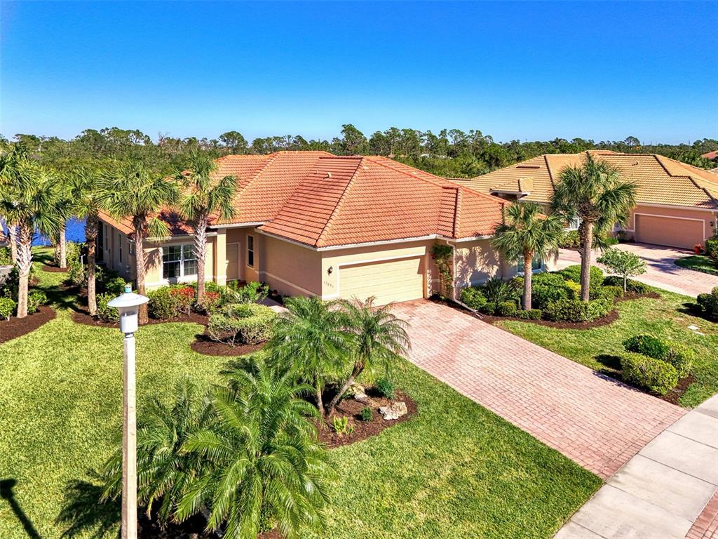 an aerial view of residential houses with outdoor space and trees