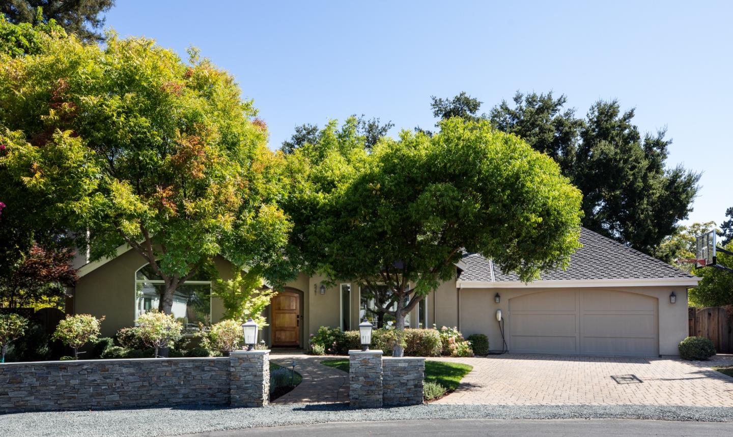 a front view of a house with a yard and a garage