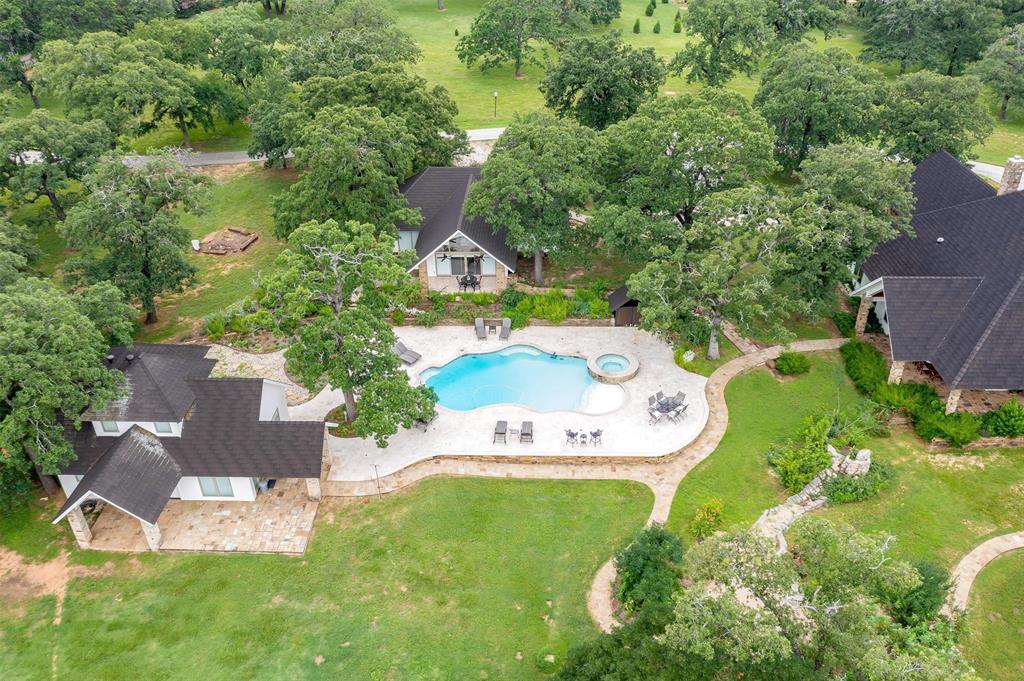 an aerial view of residential house with outdoor space and parking