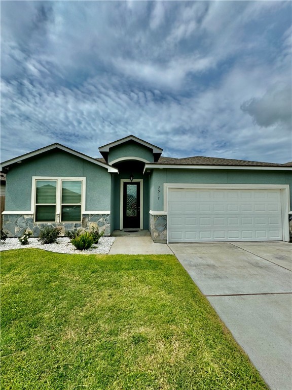 a front view of a house with yard and garage