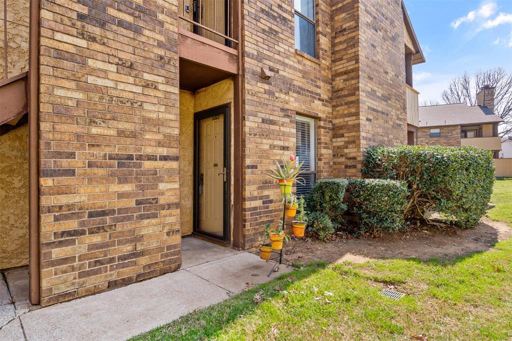 front view of a brick house with a yard