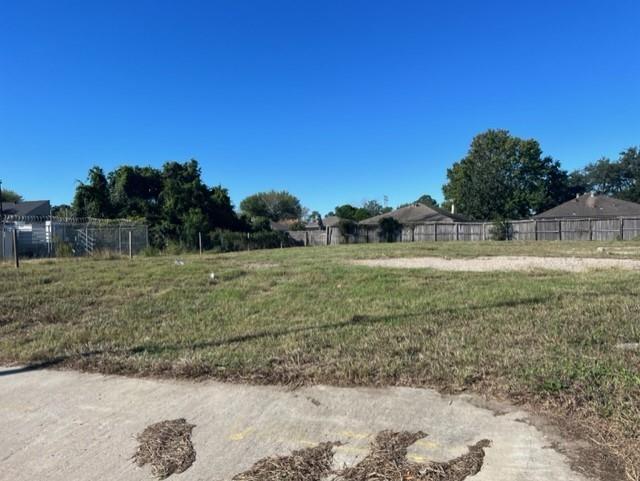 a view of a field with trees in the background