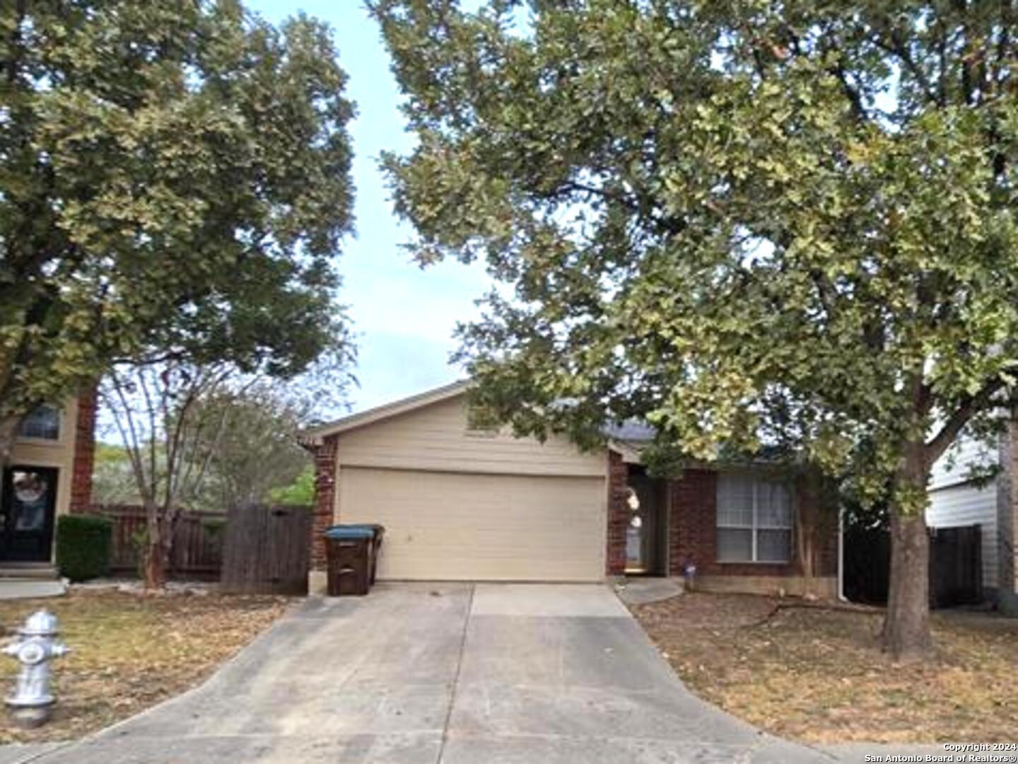 a front view of a house with a tree and garage