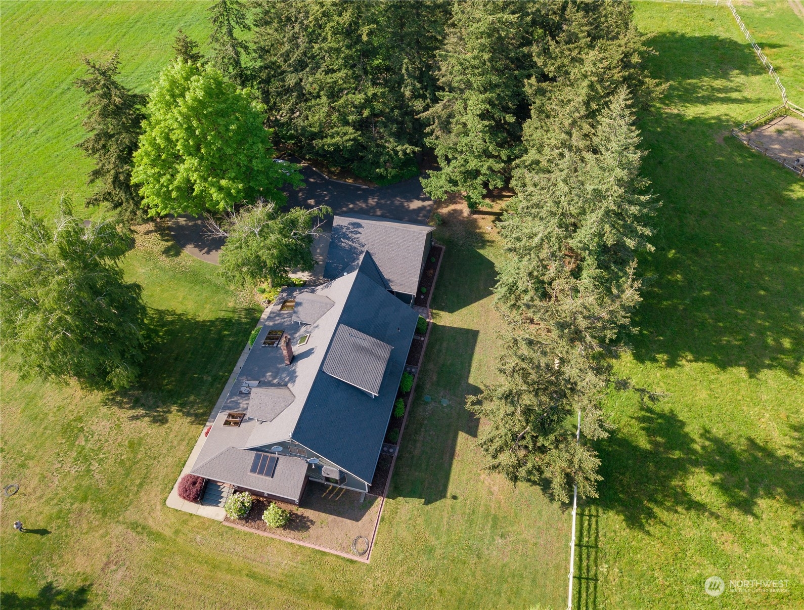 an aerial view of a house with swimming pool and garden view