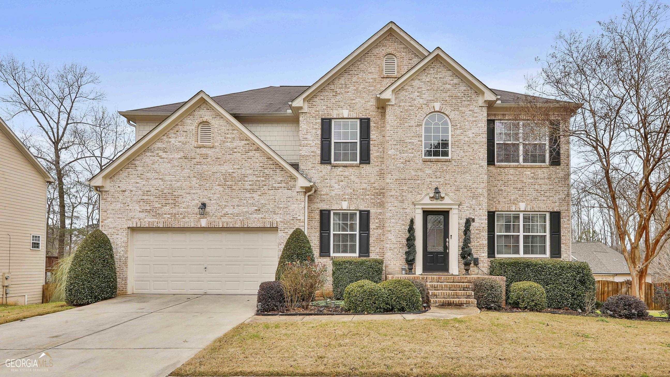 a view of a brick house with a yard