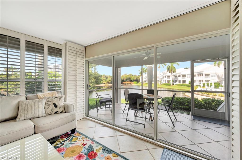 a living room with furniture and a floor to ceiling window