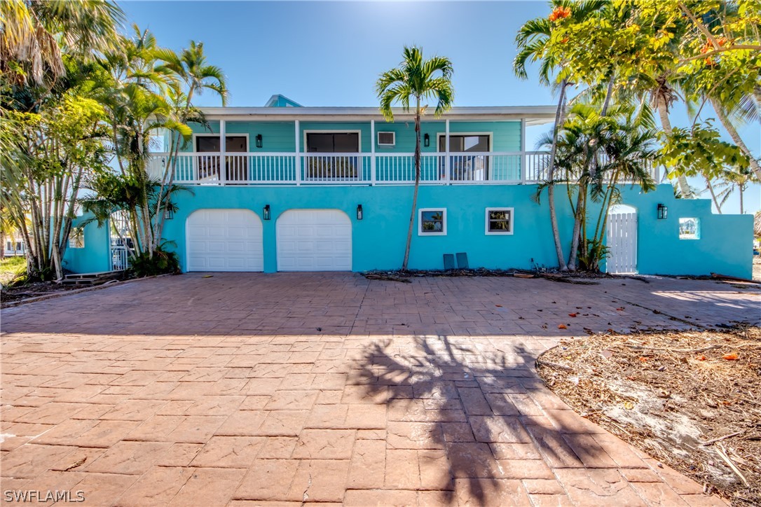 a front view of a house with a yard and a garage