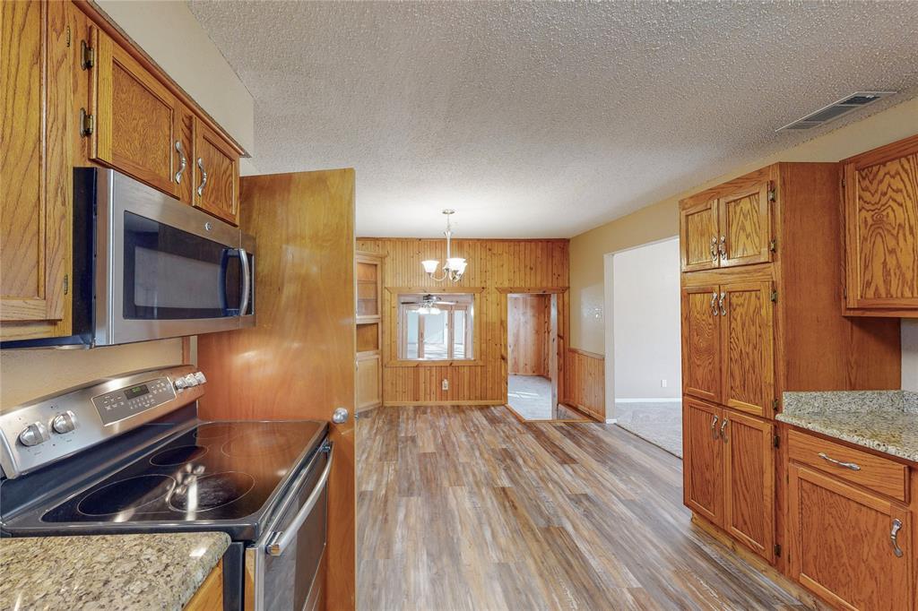 a kitchen with a refrigerator wooden floor and a sink