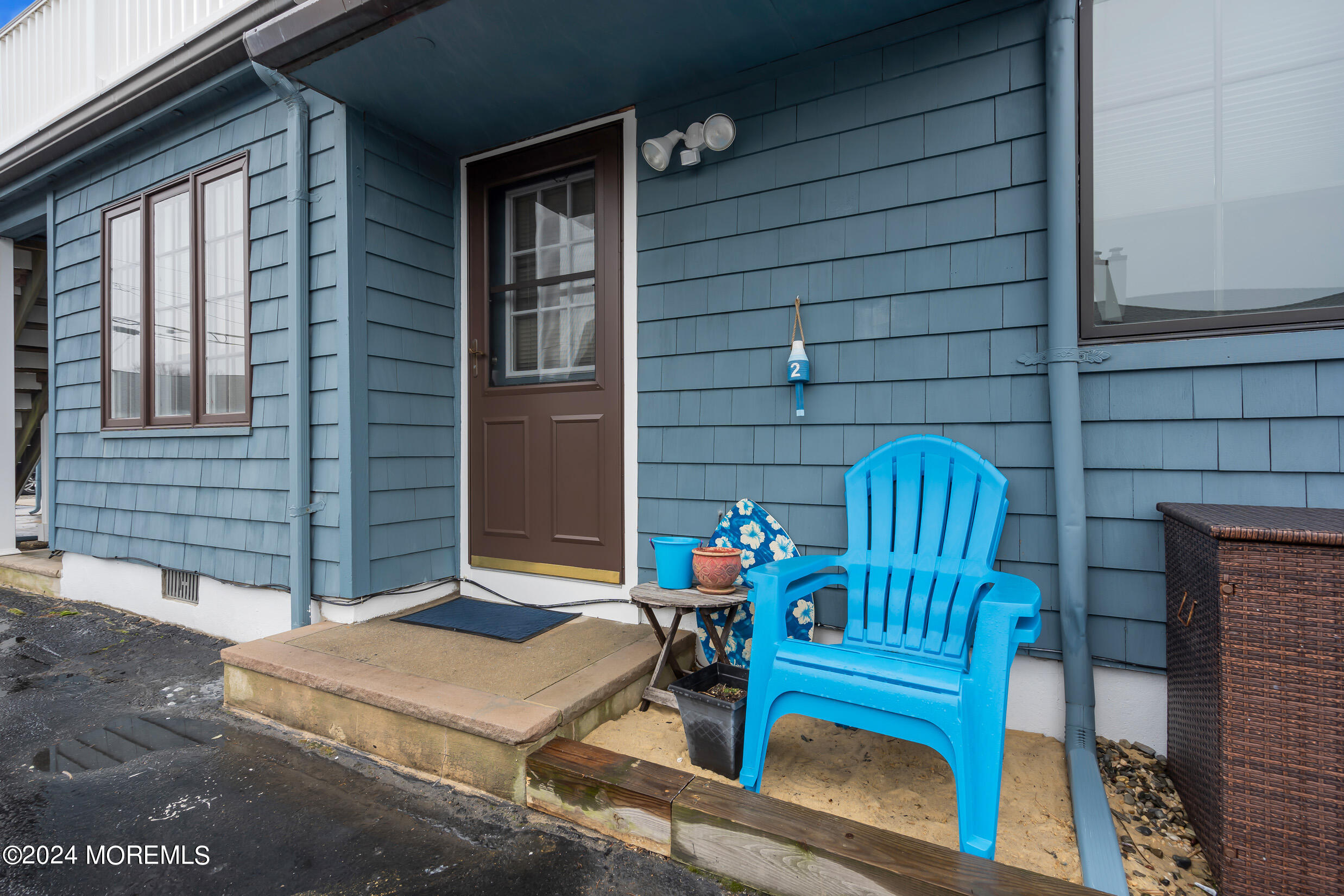 a front view of a house with outdoor seating