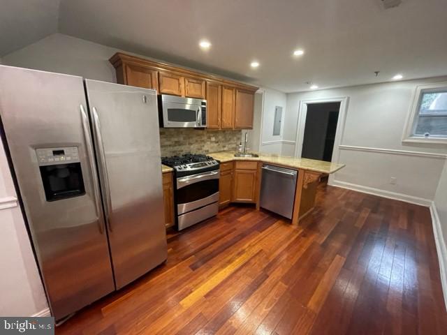 a kitchen with stainless steel appliances a refrigerator sink and microwave