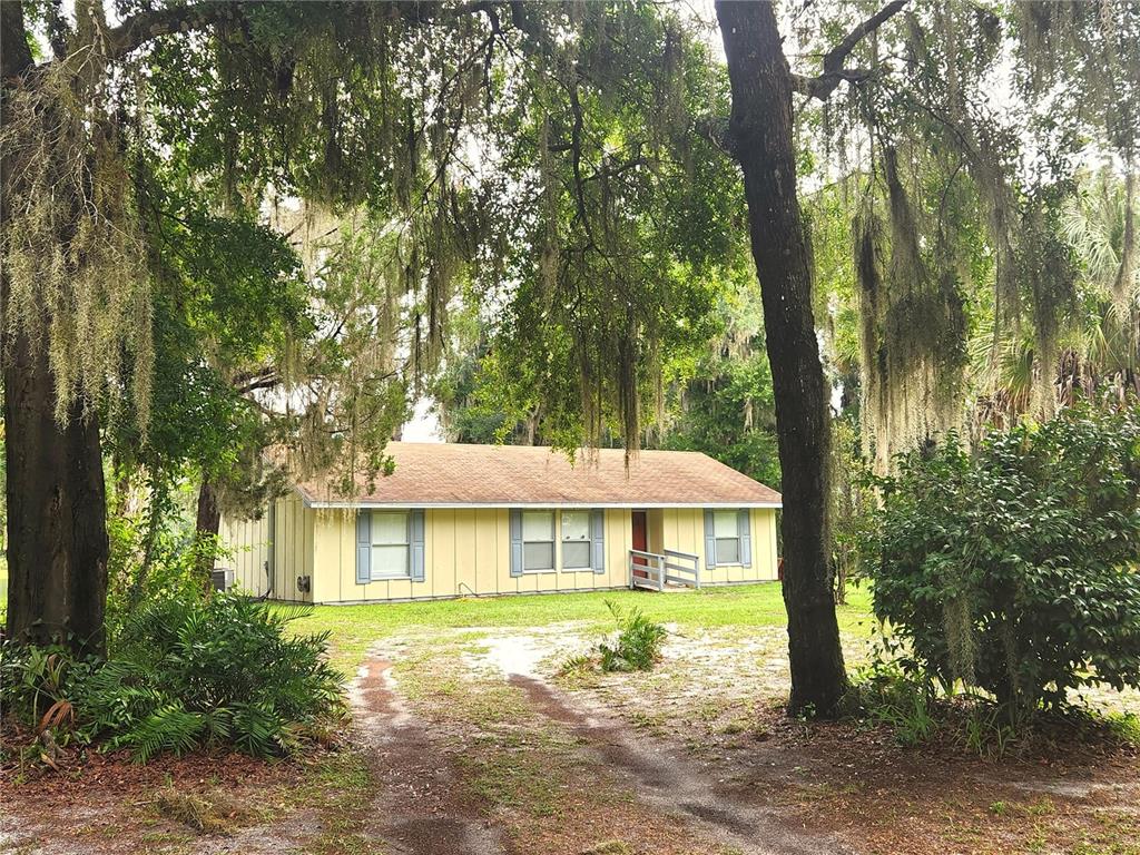 a front view of a house with yard and green space