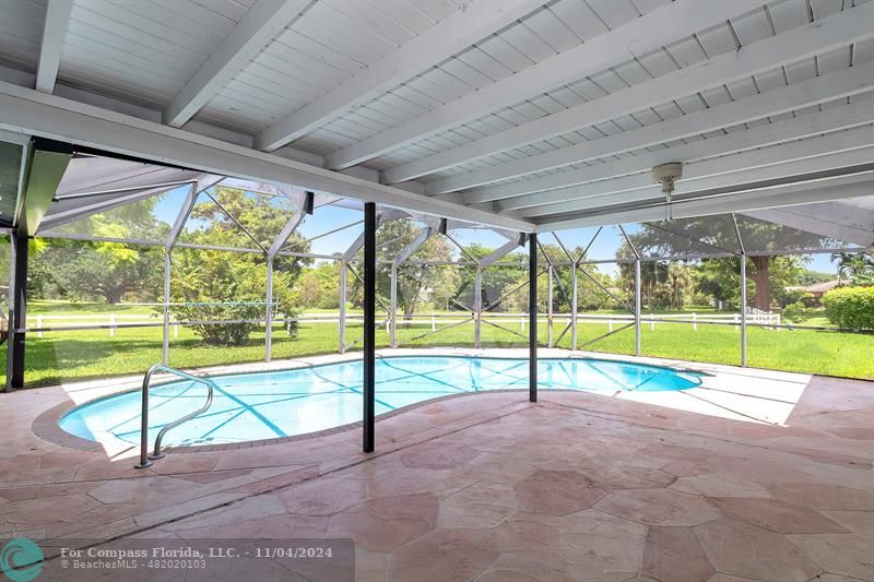 a view of a swimming pool with a yard