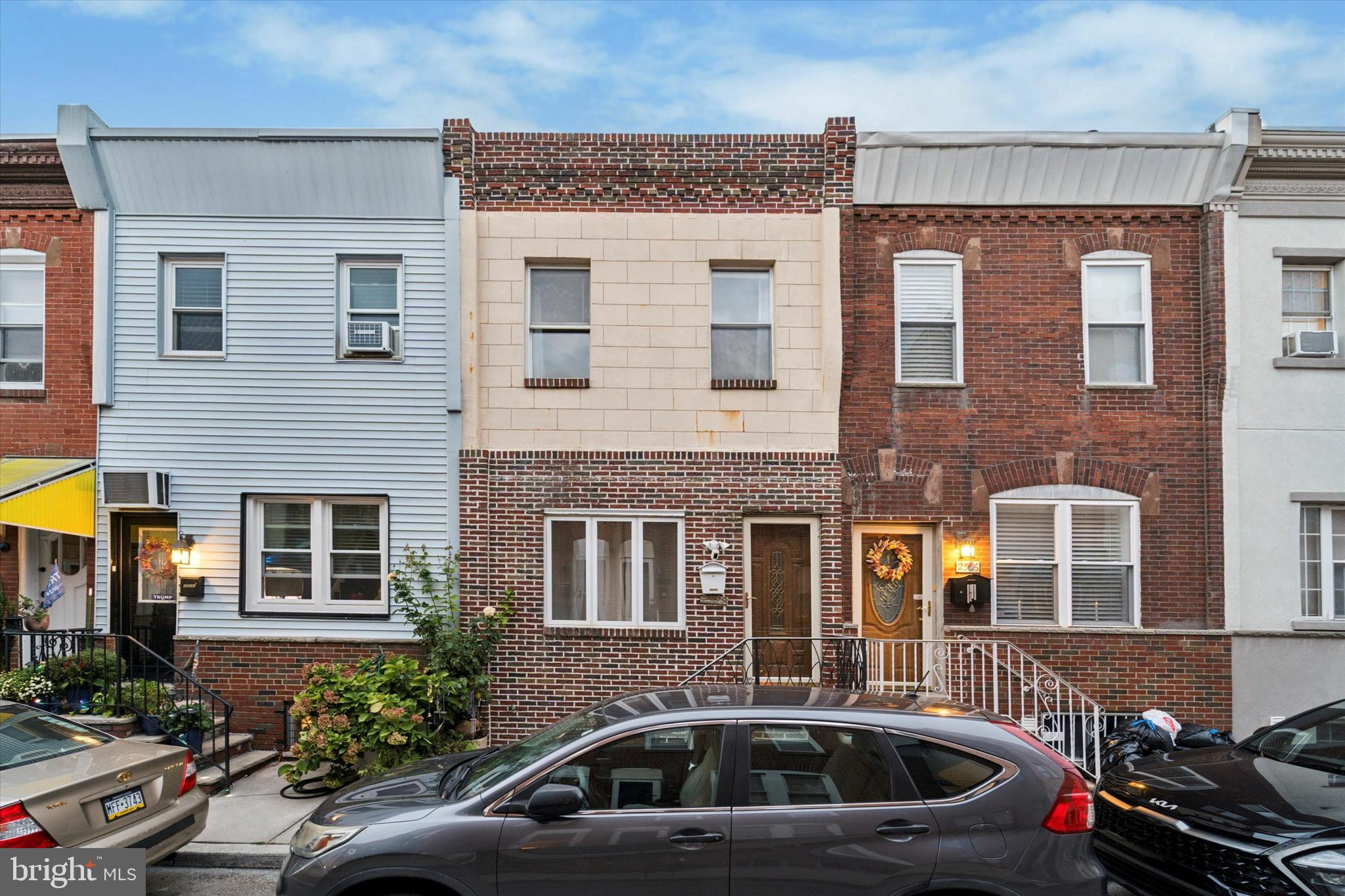 a front view of a house with car parked