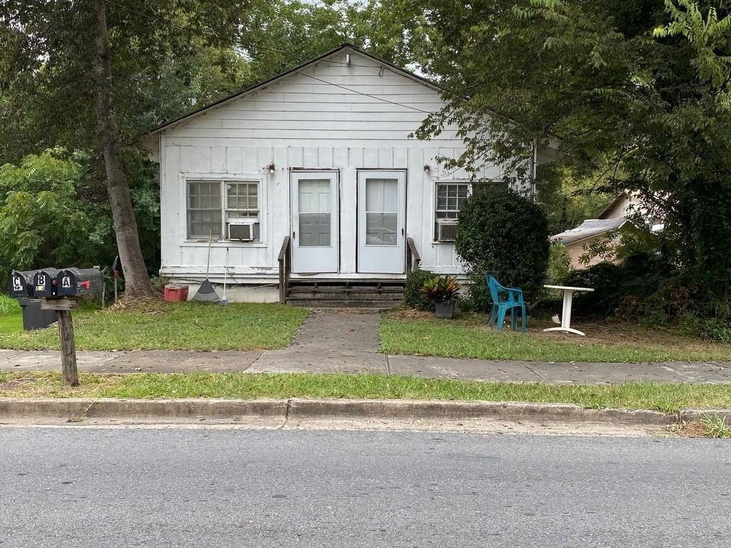 a house that has a tree in front of it