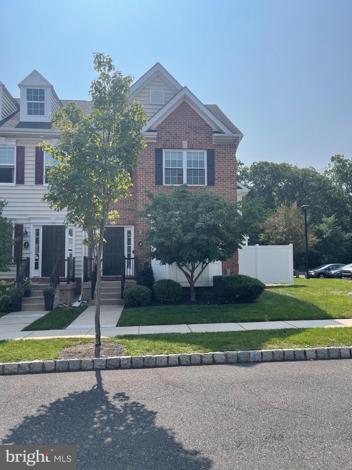 a view of a house with a yard and a fountain