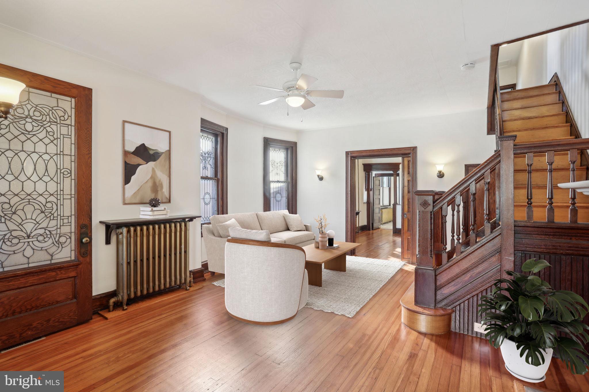 a living room with furniture flowerpot and wooden floor