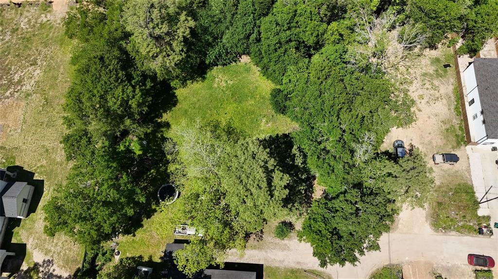 an aerial view of a residential houses with yard and swimming pool